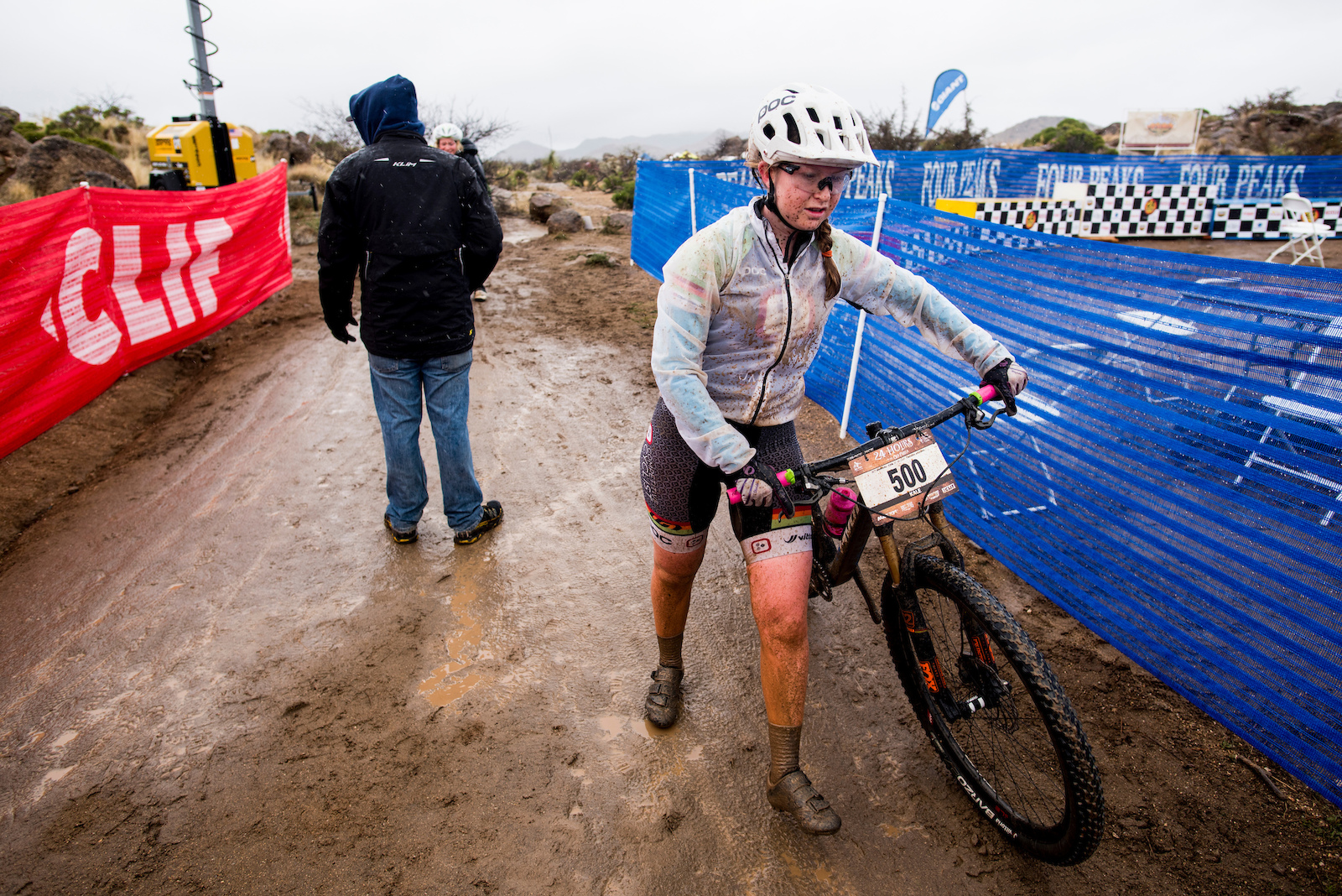 A racer walks through the exchange tent after  muddy lap Sunday morning during 24 Hours in the Old Pueblo.