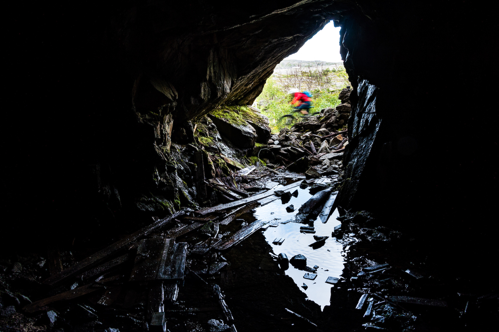 Mikael af Ekenstam riding past an old cave. During the WW2 the germans used this cave as a prison. Bj rnefjell northern Norway.