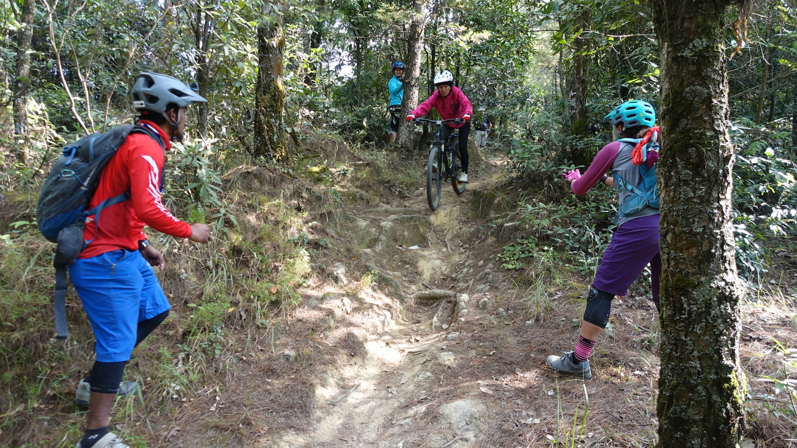 Nepali women practicing skills riding a technical drop at Nagarkot.