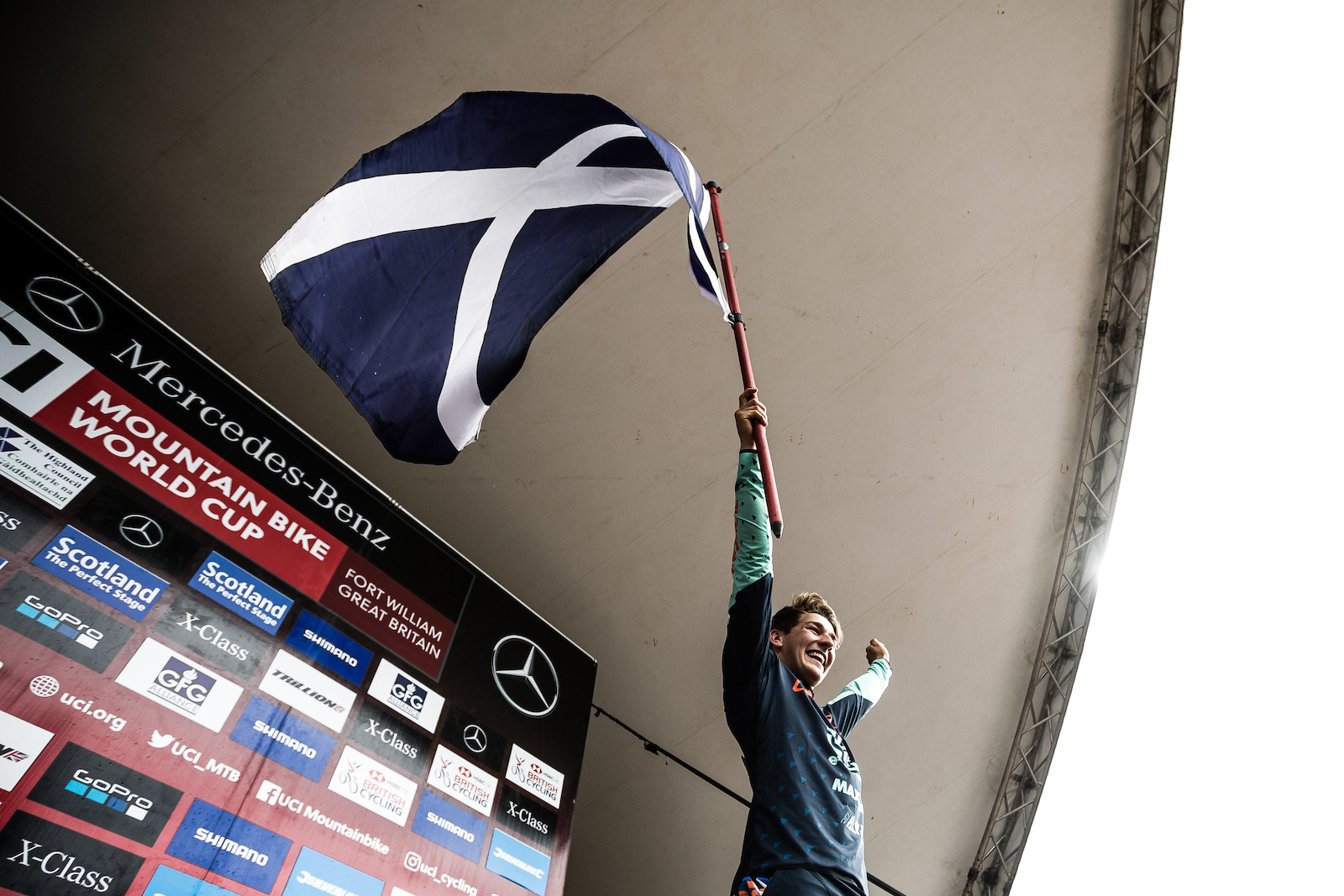 Reece hoisting the Saltire high in front of the home fans.