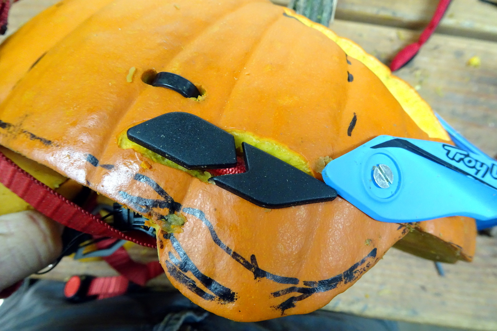 6 Use zip ties and creative slots to fix the webbing from an old lid to your fresh pumpkin.