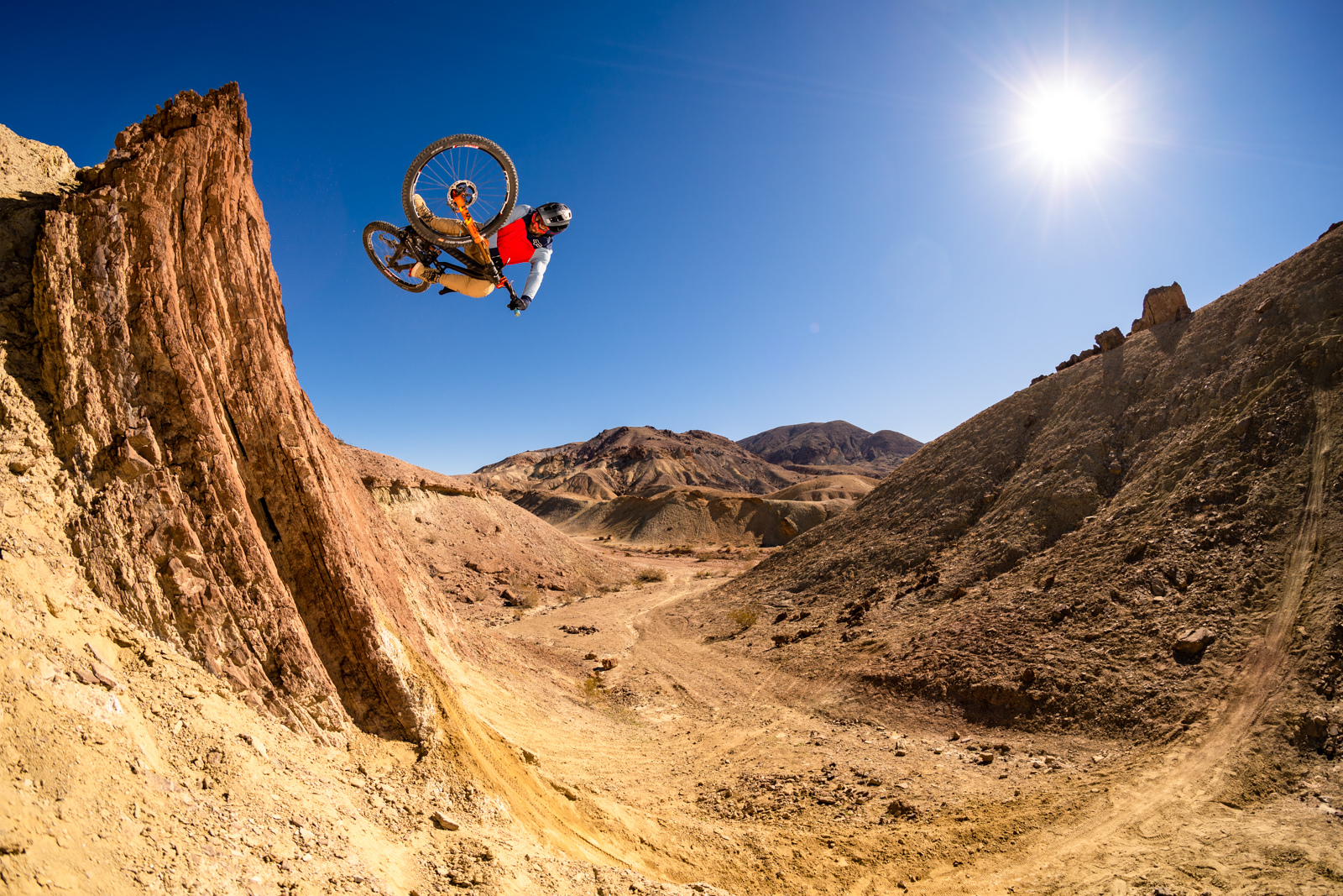 Kirt Voreis launches a lofty table in the California desert on his mountain bike.