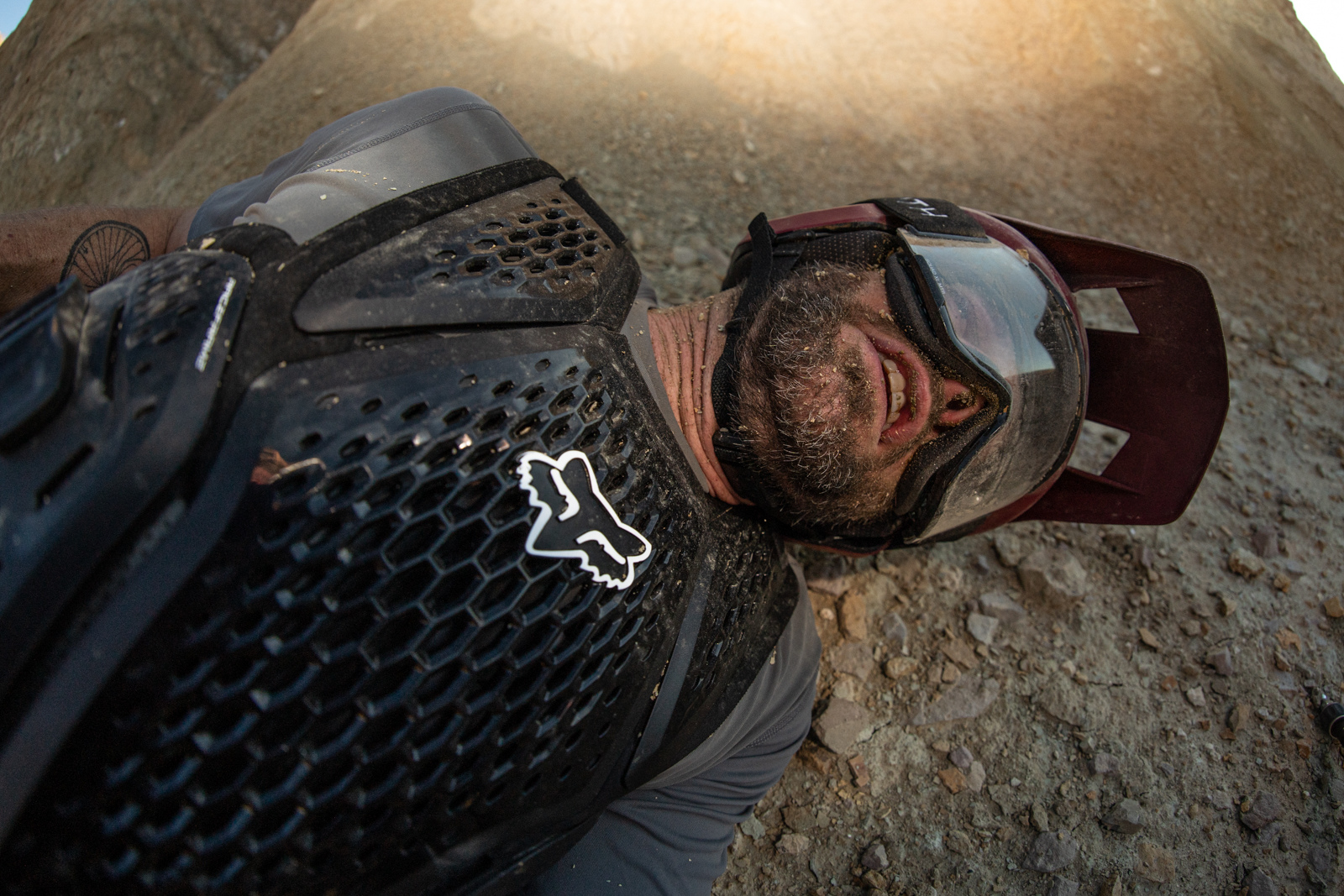 Kirt Voreis relaxes in the dirt for a minute after a crash on his mountain bike.