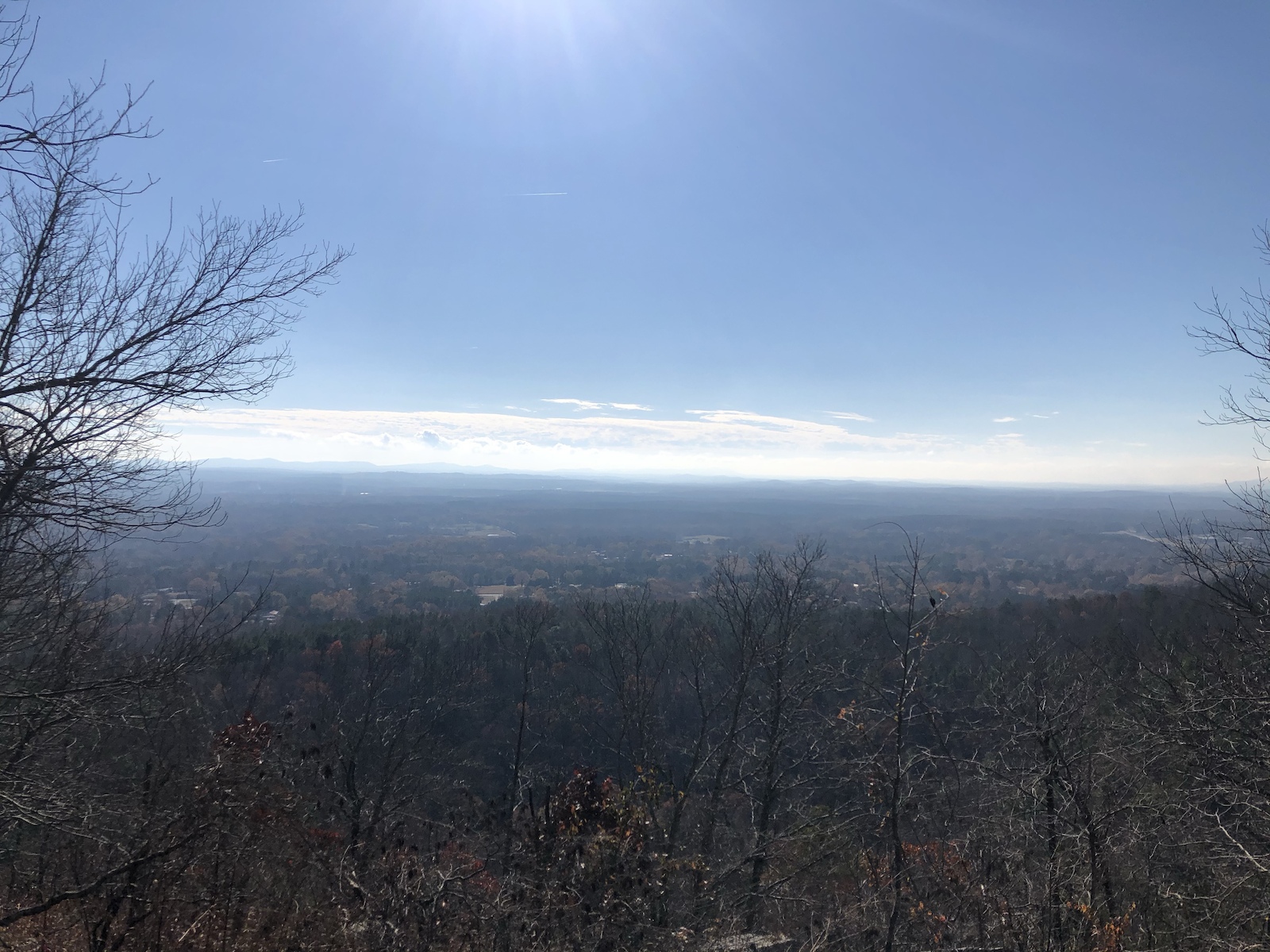 A expansive valley landscape view from a high ridge on a clear day.