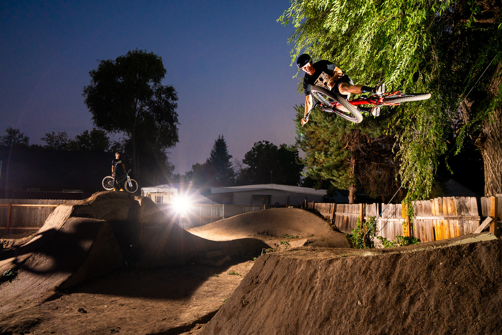 Jason Schroeder rides the dirt jumps in Austin Smiths back yard in Boise, Idaho