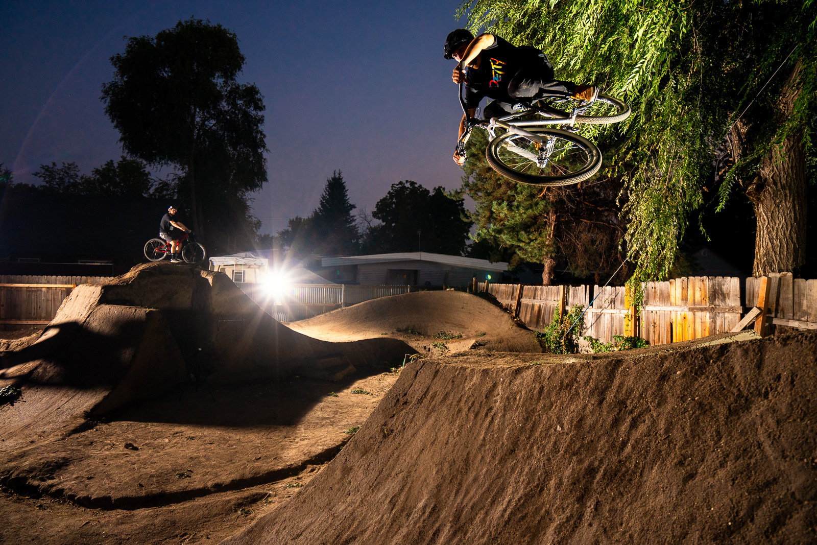 Austin Smith rides the dirt jumps in his back yard in Boise, Idaho