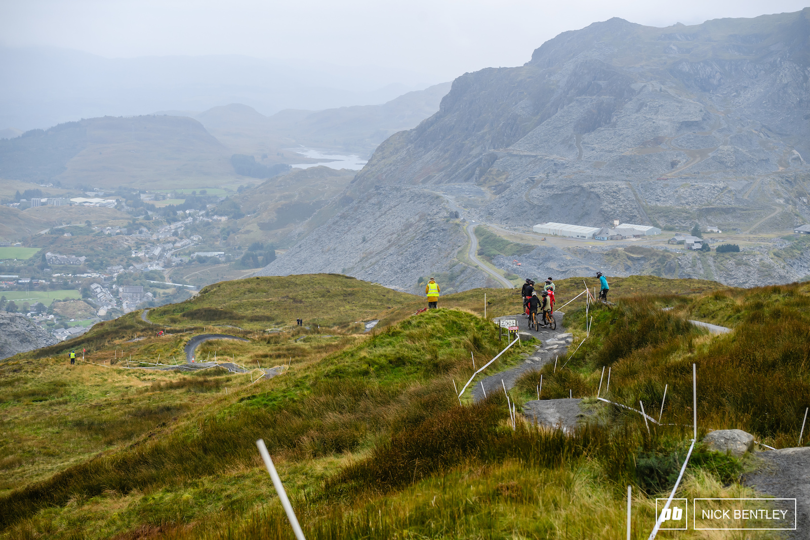 Antur Stiniog s iconic dark grey track snaking it s way down the slate strewn landscape