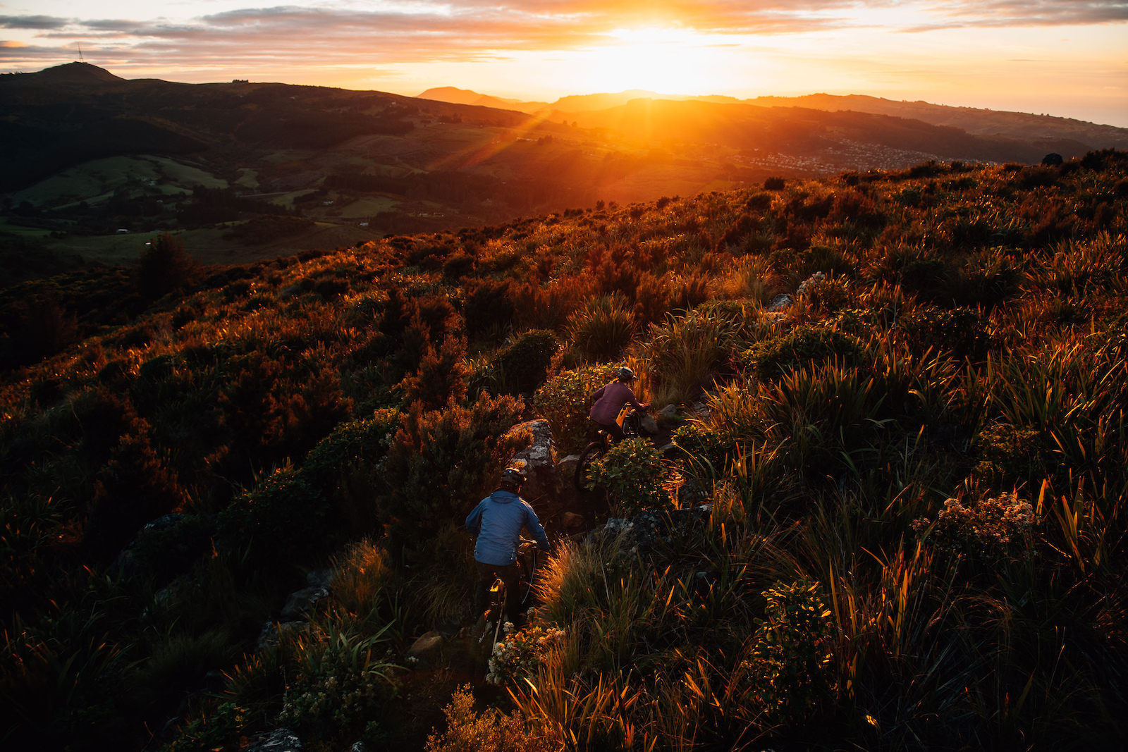 Heading down into the sunrise with a waking Dunedin in the background.