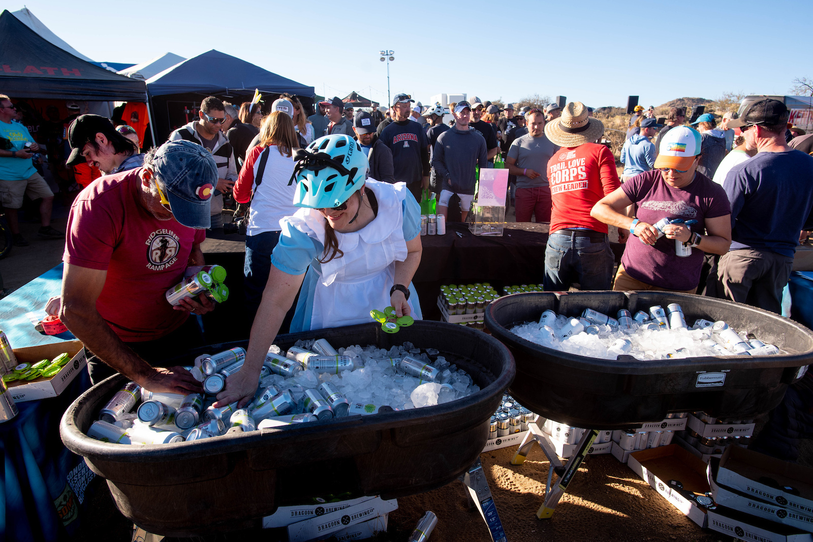 Volunteers from Sonoran Desert Mountain Bikers serve up beers during the dedication event on Friday.