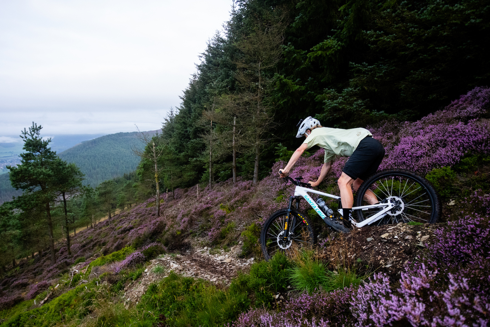 mark scott gleefully rides along a singletrack path on a crisp british afternoon
