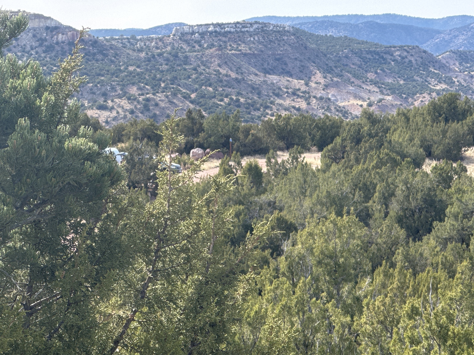Forested hillsides and mountain ridges visible across a scenic valley landscape.