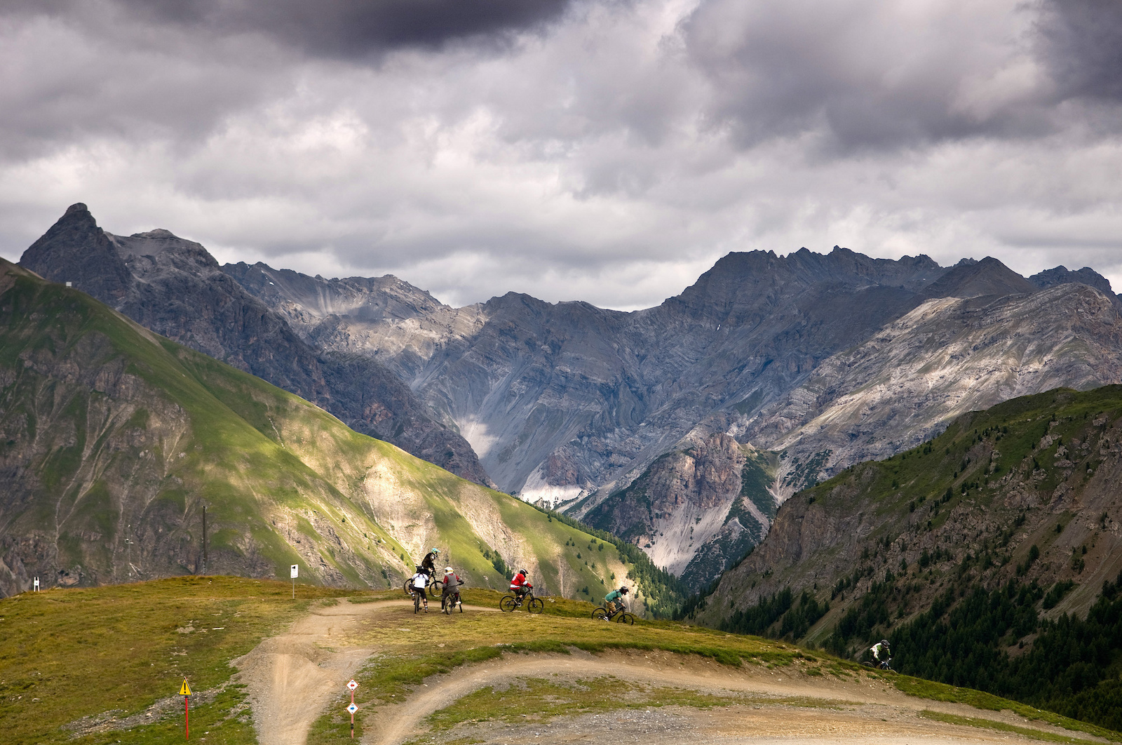 A group of riders discuss the trails, near the top of the Livigno bikepark